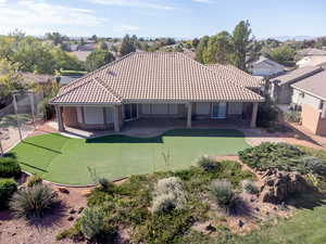 Rear view of house featuring stucco siding and a patio