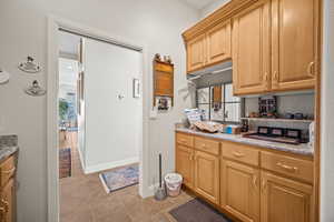 Kitchen with light tile patterned flooring and plenty of natural light