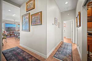Hallway with recessed lighting and light tile patterned flooring