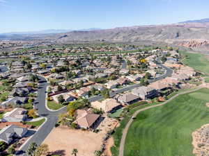 Aerial view of property's location featuring mountains, nearby suburban area, and a local golf course