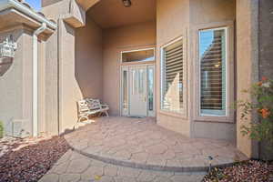 Entrance to property with a patio and stucco siding
