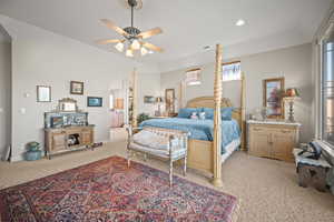 Bedroom featuring light carpet, recessed lighting, ceiling fan, and arched walkways