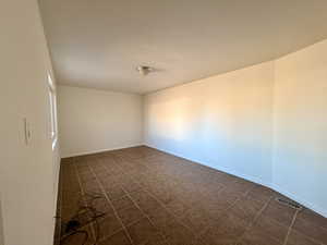 Unfurnished room featuring baseboards