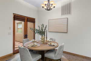 Dining space featuring baseboards and suspended lighting
