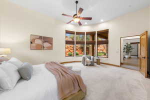 Carpeted bedroom featuring a high ceiling, ceiling fan, and recessed lighting