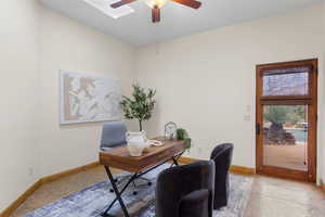 Office area with baseboards and a ceiling fan