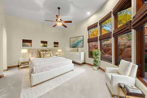 Carpeted bedroom featuring a ceiling fan, arched walkways, and recessed lighting