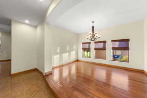 Unfurnished living room with a chandelier, light wood-style floors, and recessed lighting