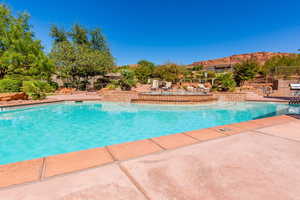 View of swimming pool featuring a patio, a mountain view, and a pool with connected hot tub