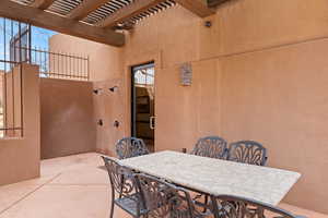 View of patio with outdoor dining area and a pergola