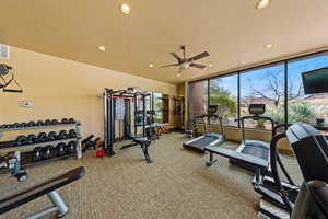 Gym with recessed lighting, ceiling fan, and expansive windows