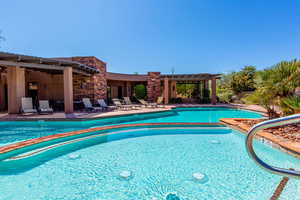 Community pool featuring a pergola and a patio