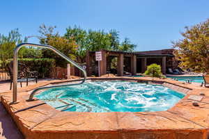 Swimming pool with a patio and a hot tub