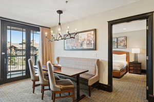 Dining room featuring light carpet and a chandelier