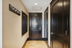 Doorway to outside with tile patterned floors and recessed lighting