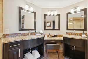 Bathroom with vanity, decorative backsplash, and light tile patterned floors
