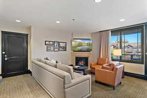 Living area featuring recessed lighting and a glass covered fireplace