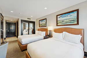 Bedroom featuring recessed lighting, a closet, tile patterned flooring, and carpet flooring