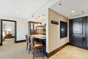 Foyer entrance with recessed lighting and light carpet
