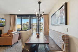 Dining room featuring a chandelier, recessed lighting, and a glass covered fireplace