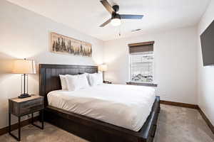 Bedroom with light carpet and ceiling fan