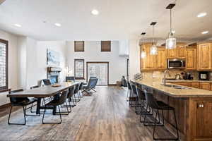 Dining space with recessed lighting, a fireplace, dark wood finished floors, french doors, and a textured ceiling