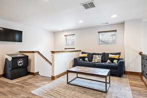 Living area featuring light wood-type flooring and recessed lighting