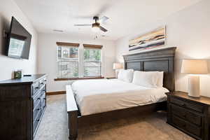 Bedroom featuring light colored carpet and a ceiling fan