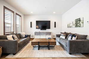 Living room featuring wood finished floors and recessed lighting