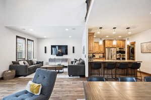 Living area featuring light wood-type flooring, recessed lighting, and stacked washing machine and dryer