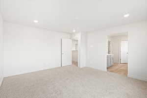 Unfurnished room featuring light carpet and recessed lighting