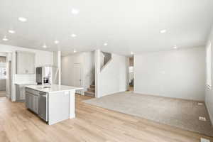 **DISCLAIMER - INTERIOR & EXTERIOR options may vary. Kitchen with a kitchen island with sink, recessed lighting, gray cabinetry, stainless steel fridge with ice dispenser, and decorative backsplash