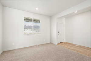 Unfurnished room featuring light carpet and recessed lighting