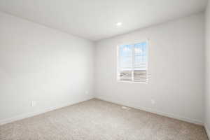 Unfurnished room with carpet floors and recessed lighting