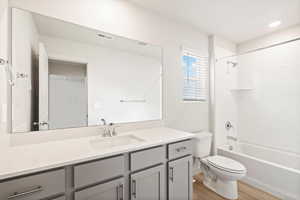 Full bathroom featuring vanity, light wood-style flooring, and bathing tub / shower combination