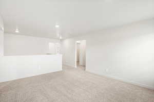 Empty room featuring carpet flooring and recessed lighting