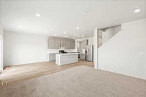 **DISCLAIMER - INTERIOR & EXTERIOR options may vary. Unfurnished living room featuring recessed lighting, light colored carpet, and light wood-style floors