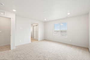 Spare room with light colored carpet, recessed lighting, and a smoke detector