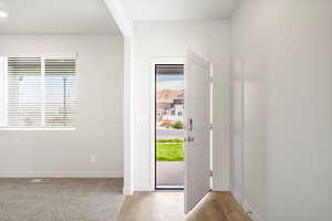 Entrance foyer featuring baseboards and light wood-style floors
