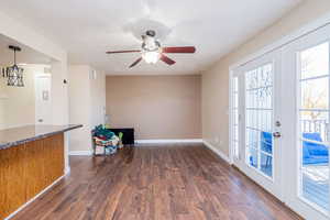 Unfurnished room featuring french doors, a textured ceiling, dark wood finished floors, and ceiling fan