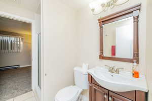 Bathroom with light colored carpet, light tile patterned floors, vanity, and a stall shower