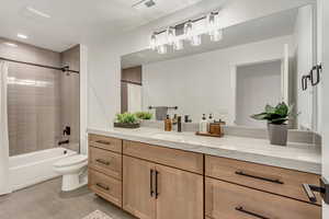 Full bathroom featuring vanity, shower / tub combo with curtain, light tile patterned flooring, and recessed lighting