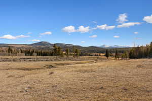 View of mountain backdrop with rural landscape