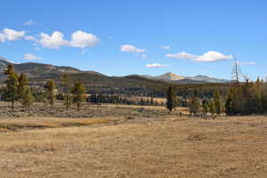 View of mountain backdrop with rural landscape