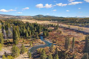 Aerial view of sparsely populated area with a water and mountain view