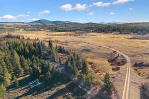 Aerial overview of property's location with a mountainous background and rural landscape
