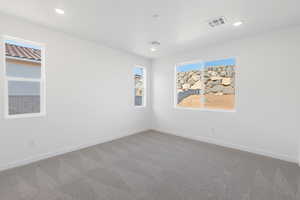 Carpeted spare room featuring baseboards and recessed lighting