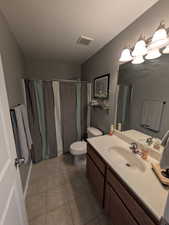 Bathroom with vanity, a textured ceiling, light tile patterned floors, and a shower with curtain