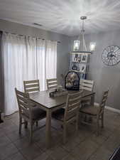Dining area featuring a textured ceiling and tile patterned floors