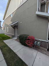 Property entrance with stucco siding and board and batten siding
